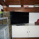 Schlafzimmer mit Sideboard und weiterer SAT TV
