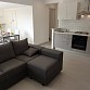 Modernes Wohn/Esszimmer mit grossem Sofa, Sideboard, SAT TV